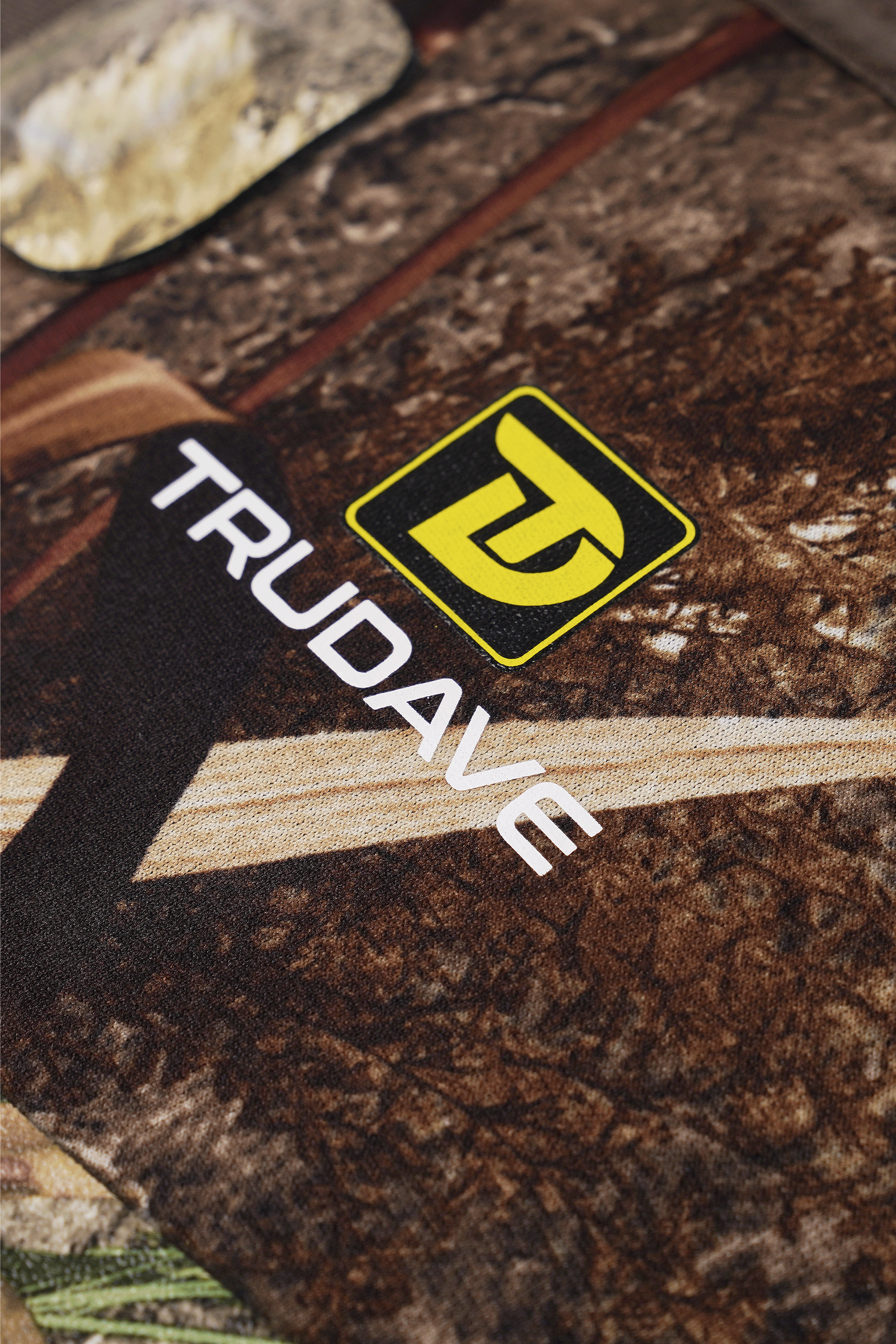 alt="Close-up of the boot shaft on Trudave WildGuard Series men’s tall waterproof camo hunting boots in Reed Grass color showing embossed Trudave brand logo, reinforced upper material, and waterproof camo design that highlights durability and premium outdoor craftsmanship"